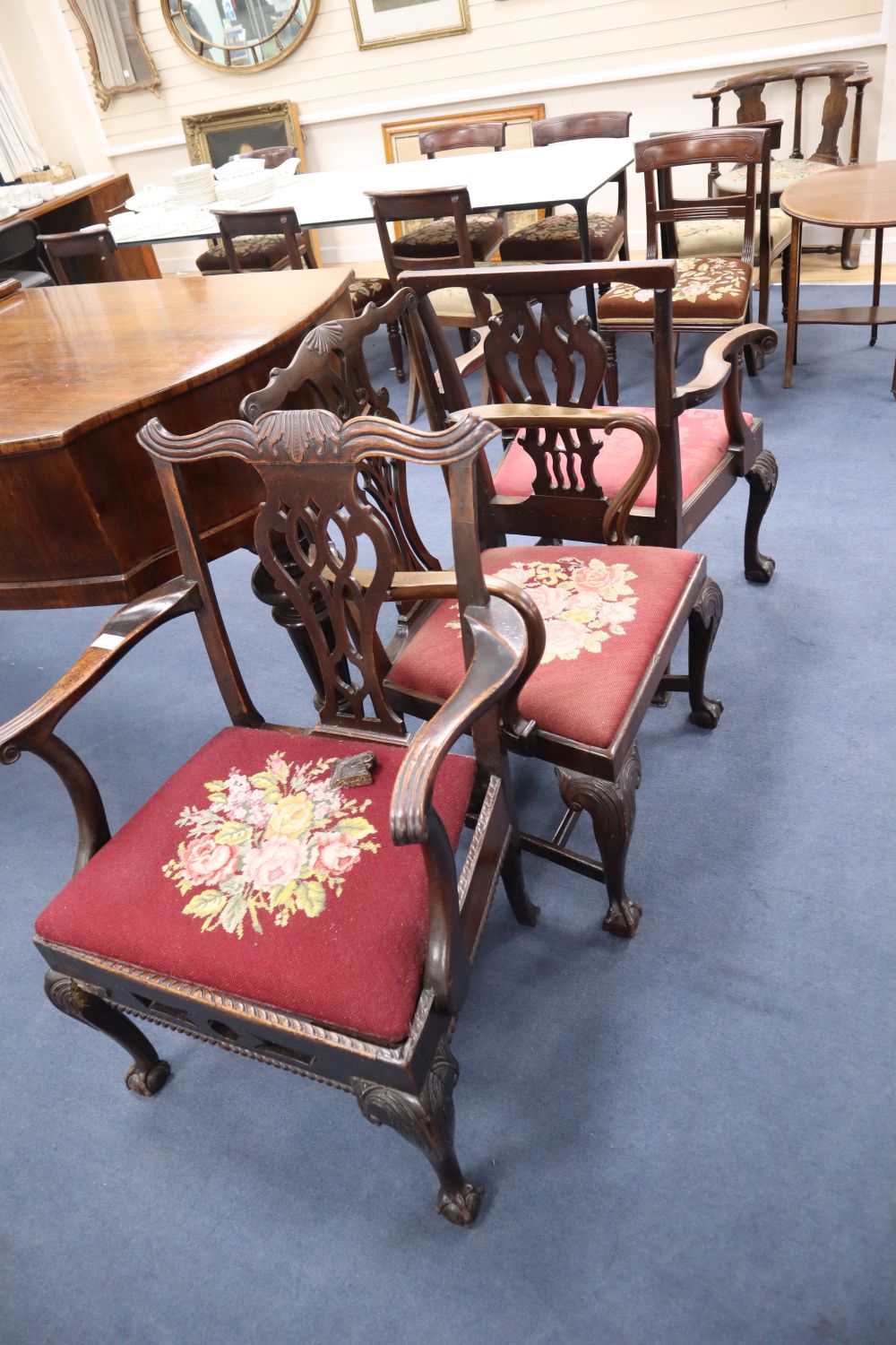 Three George III carved mahogany elbow chairs
